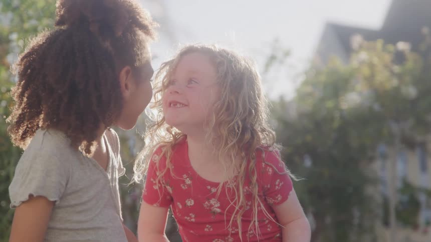 Girls playing happily in the garden