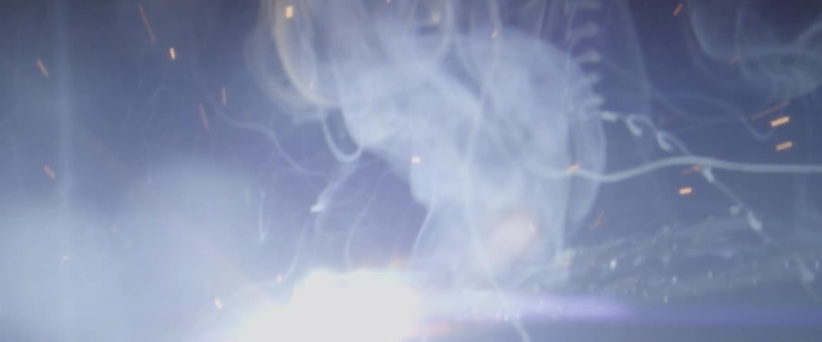 Someone welds in a dark room
