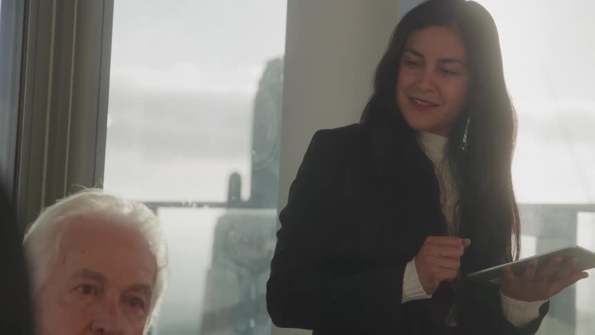 A woman looks down at a man sitting next to her