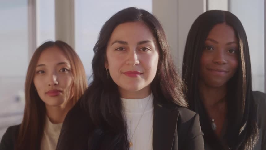 Portrait of three women in blazers in an indoor space