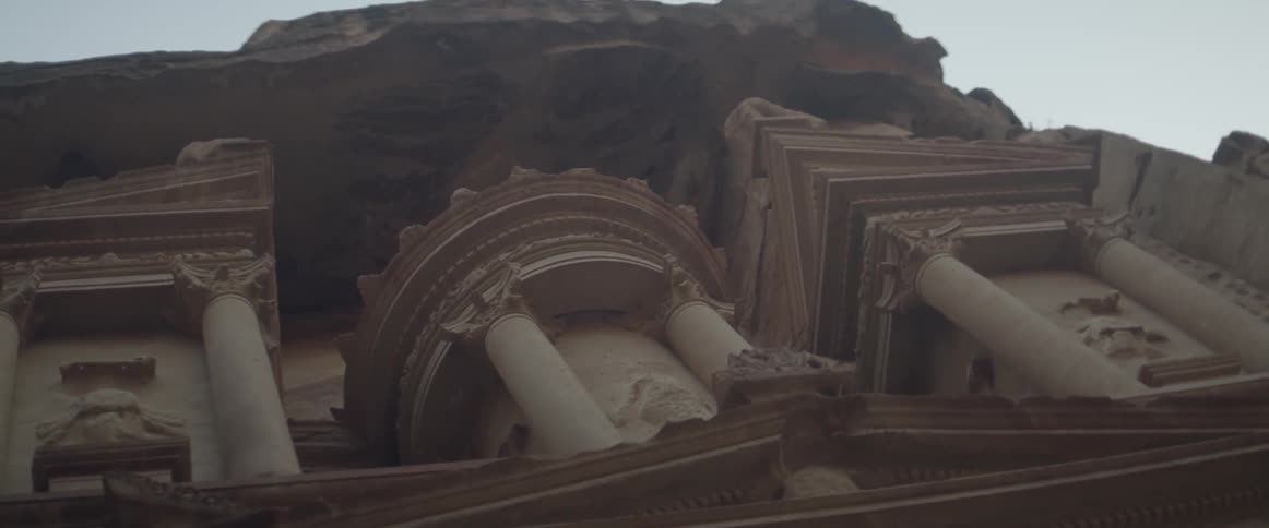 The stone building has pillars around it