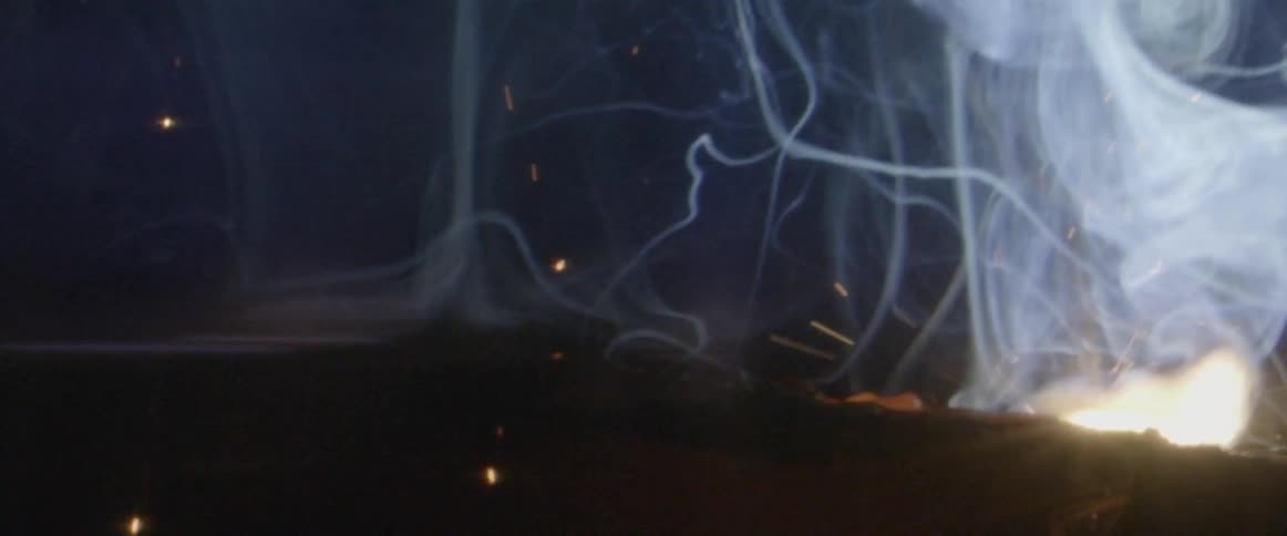 Sparks and smoke fly through the air as an object is welded