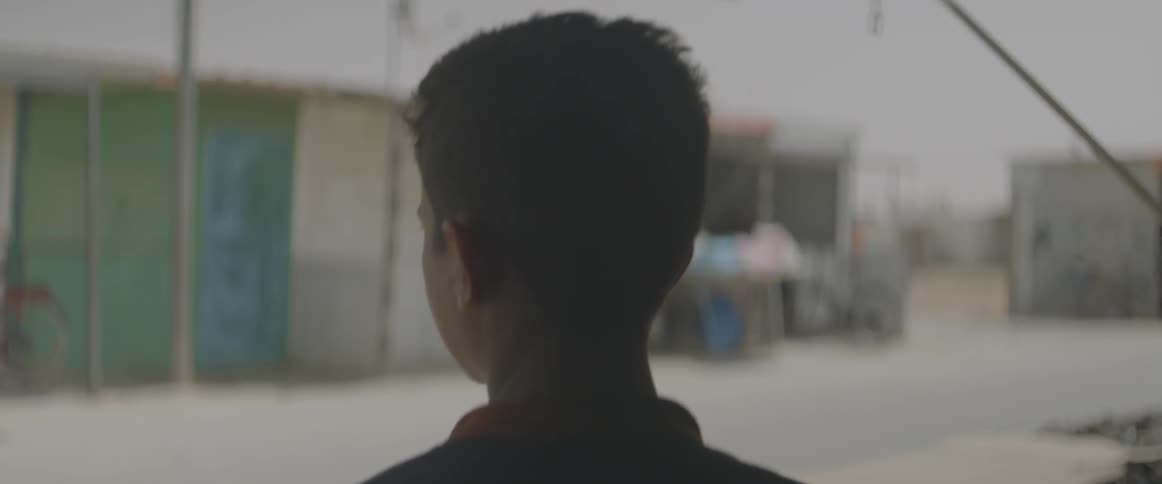 Teenage male looking into an alleyway