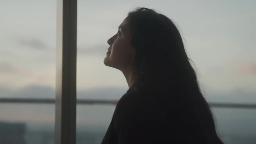 Woman walking through a panoramic room in a building