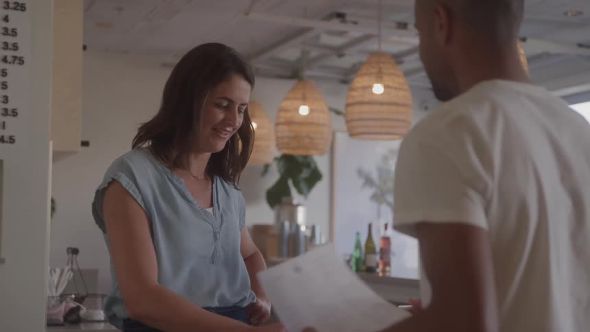 Man and a woman talking in an indoor space