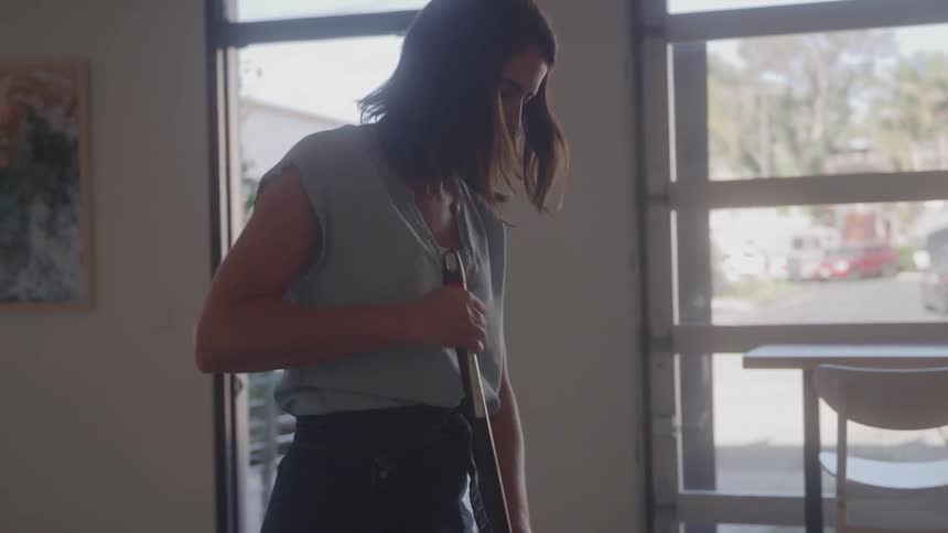 Woman with a broom cleaning a business