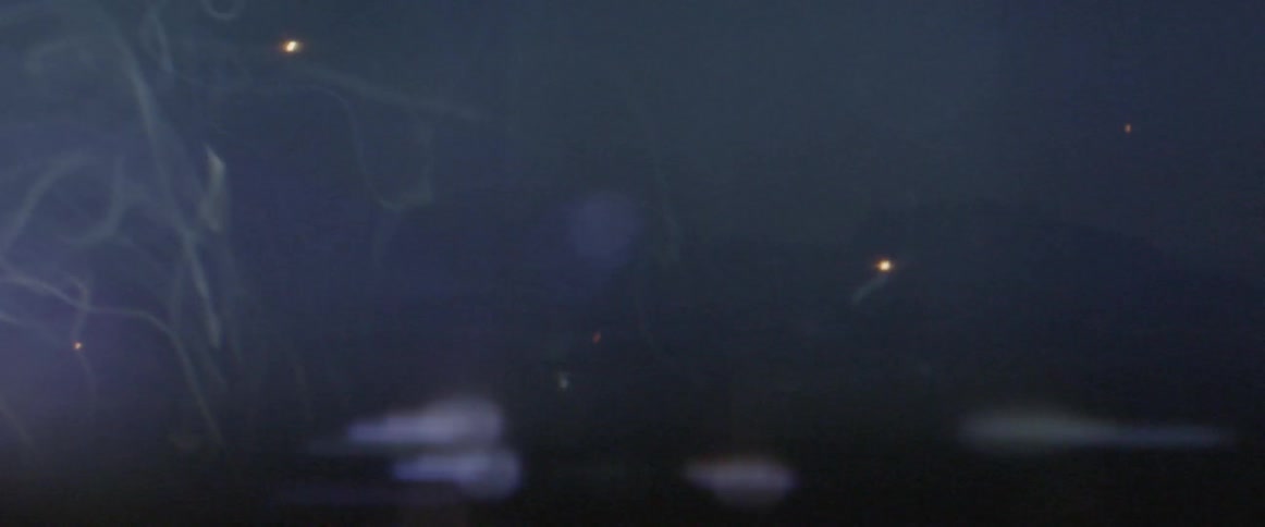 Sparks and smoke lift into the air as a man welds