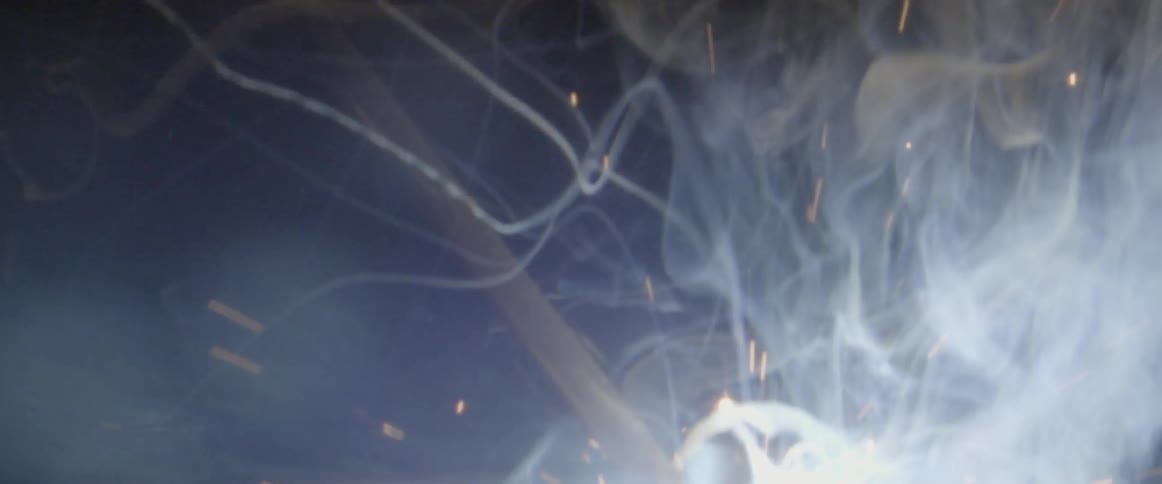 Sparks and smoke lift into the air
