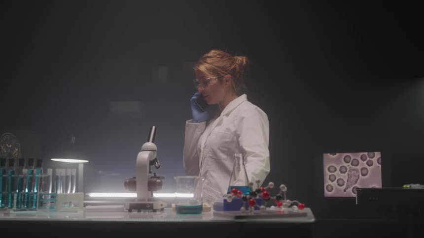 A scientist in a laboratory talking to someone on the phone