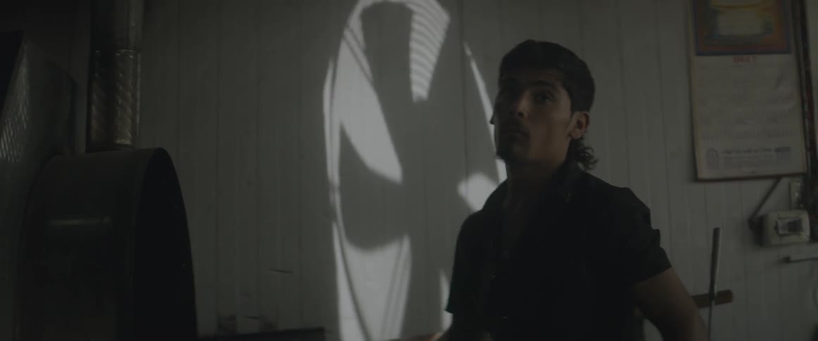 A man looks around in a dark room