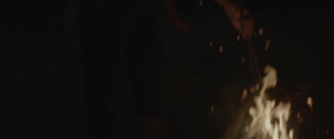 A fire is burning bright at night