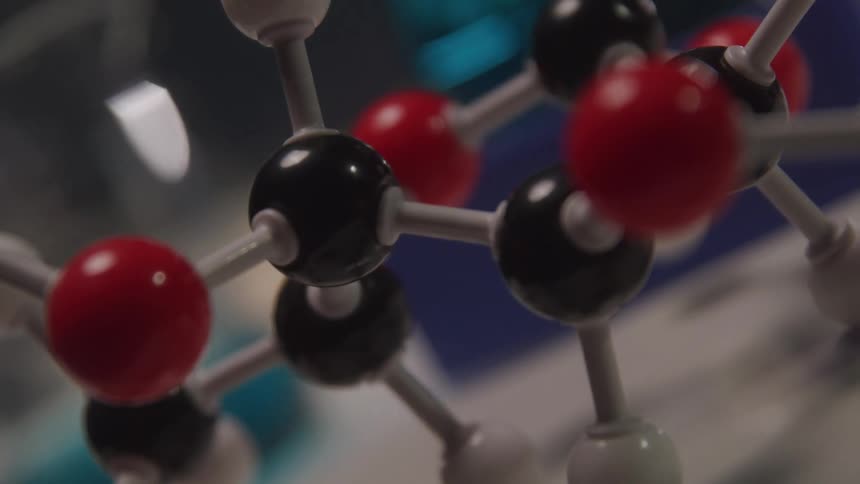 Close up of a black and red molecule object in a laboratory