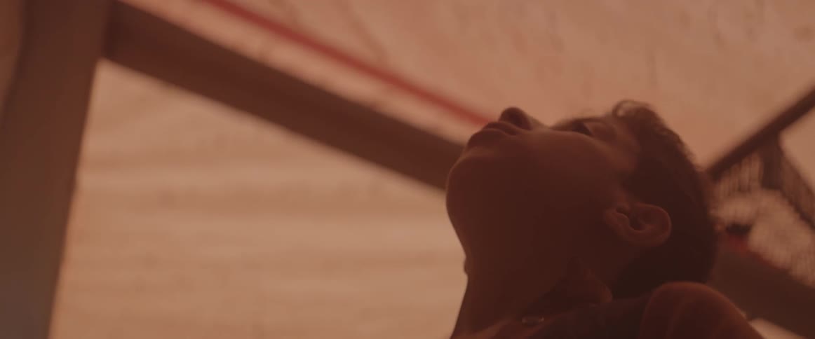 A young boy looks up and around at the tent he's in