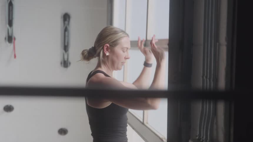 Blonde woman opening the door of a studio