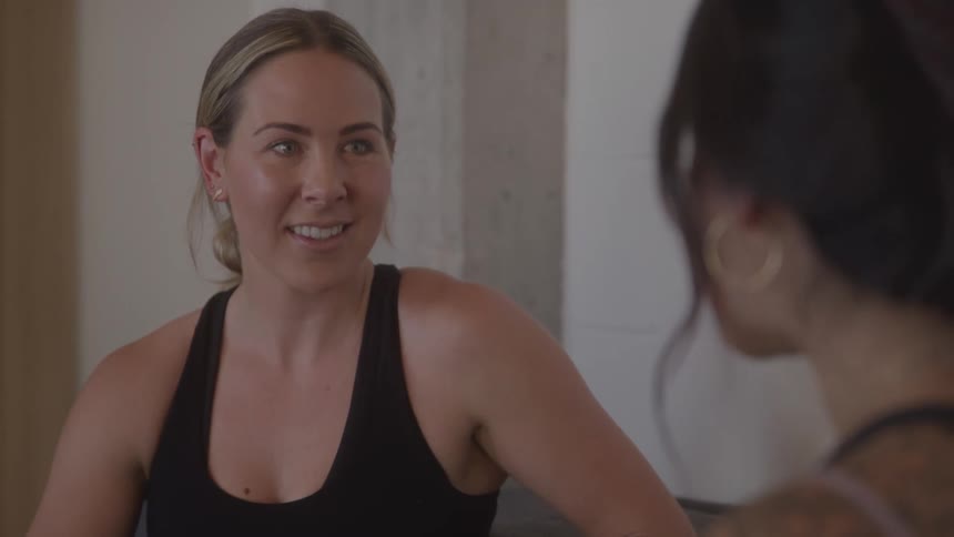 Two women in an indoor space talking