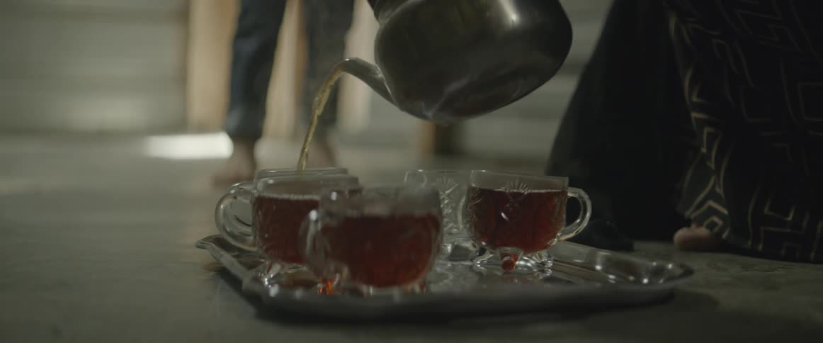 Tea is being poured into glasses