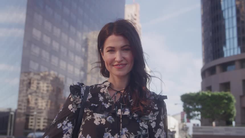 Woman with a smile on her face in an urban environment