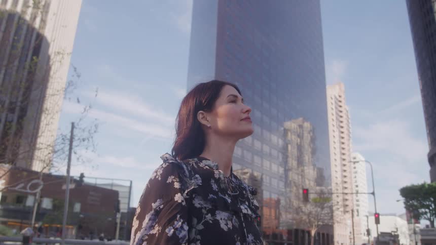 Woman outdoors in a metropolis with modern skyscrapers