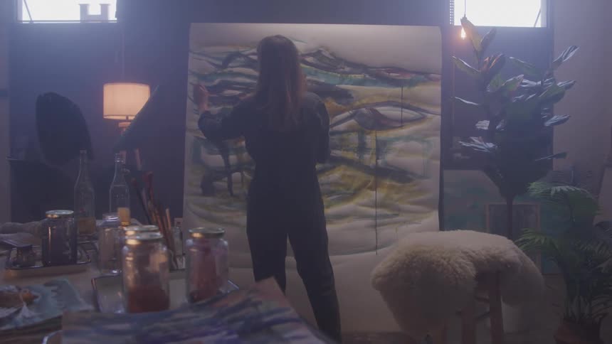 Woman painting a white canvas