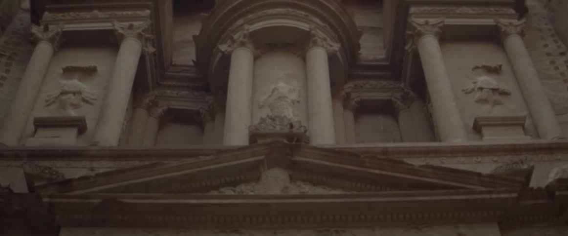 The wall is carved into a building with pillars
