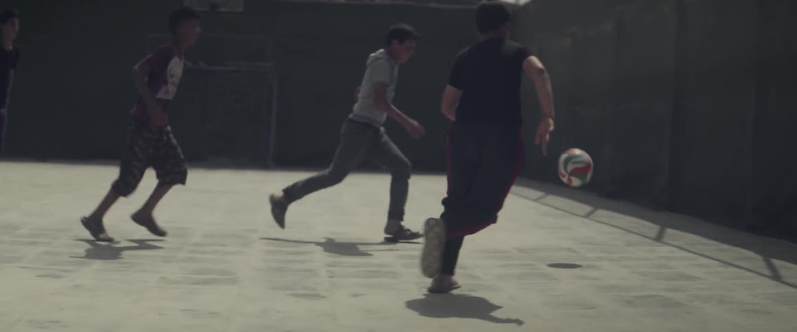 Kids are playing soccer in a court