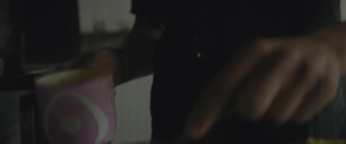 A man spreads an ingredient on round dough