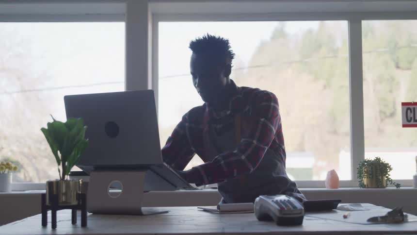 An employee types onto a computer