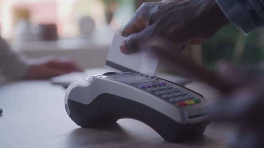 The man pays with a credit card