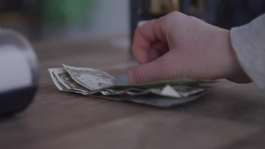 A customer counts out money to pay