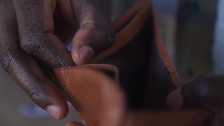A man opening his wallet and looking for cash