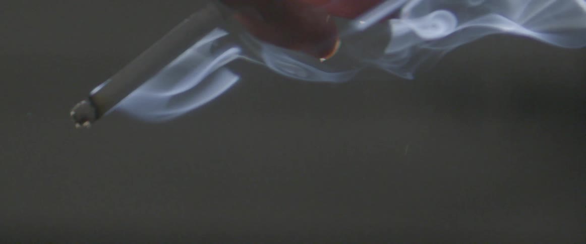 A light cigarette held in someone's hand
