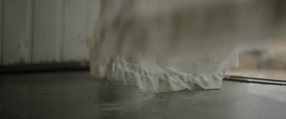 The wind blows window drapes
