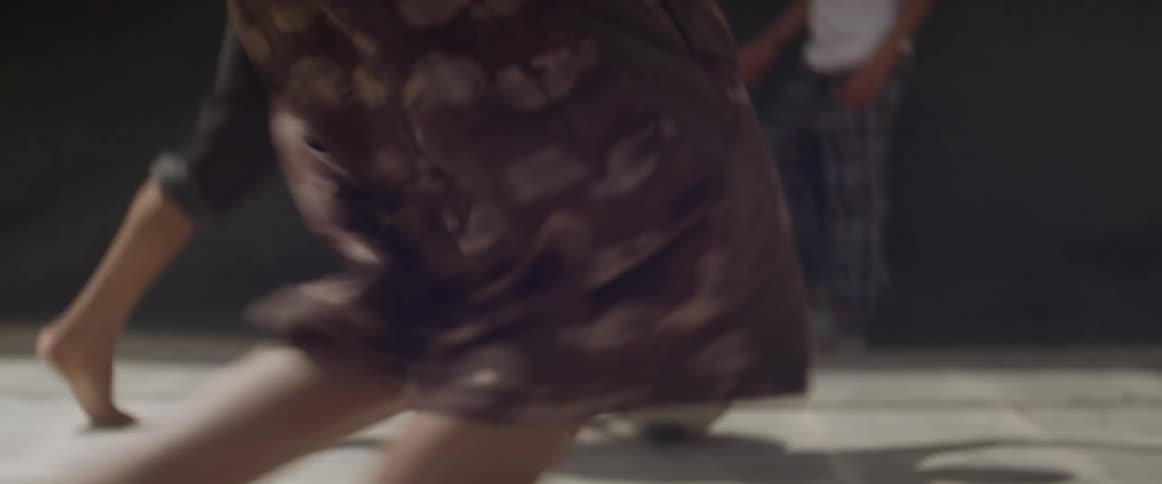 Barefoot children run and kick a soccer ball