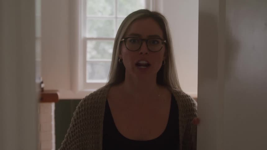 A woman yells at the camera before slamming the door
