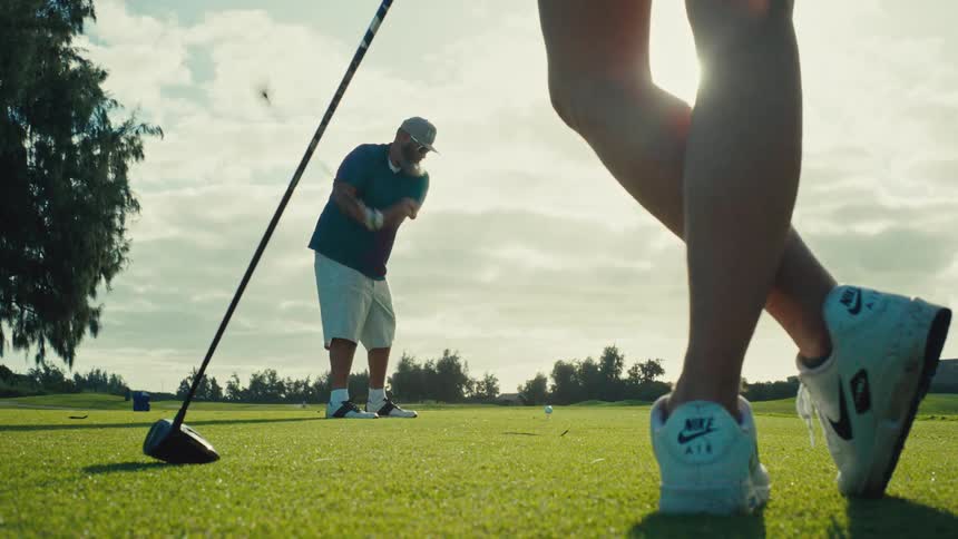 The man hits the golf ball with his driver