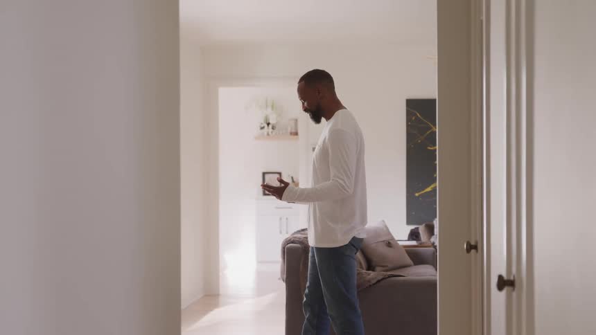 Man talking on cell phone in a room of the house
