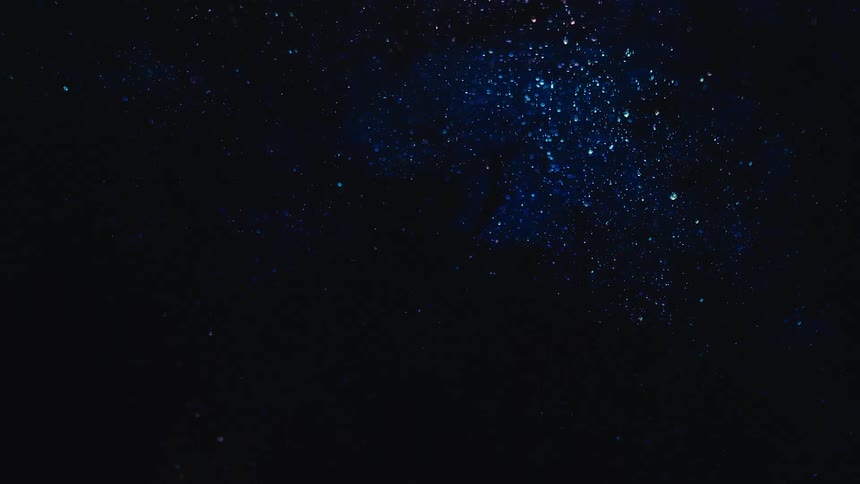 The bubbles slowly rise in the dark waters below