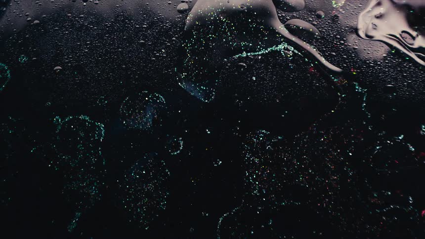 Waves in an oily fluid causes bubbles to rise to the surface