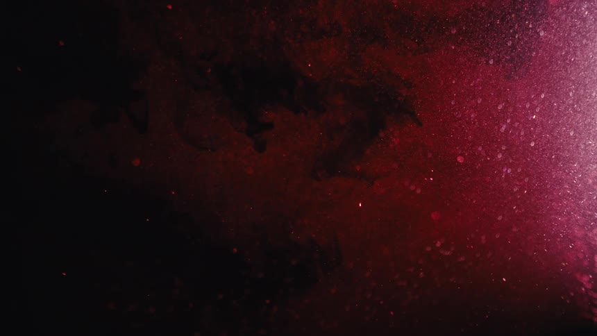 Abstract closeup on a bright red liquid with black