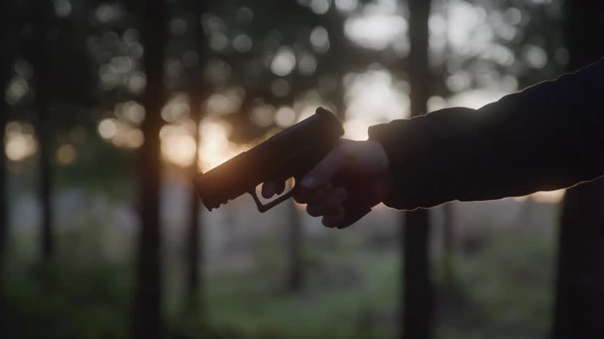 Man holding the trigger of a pistol