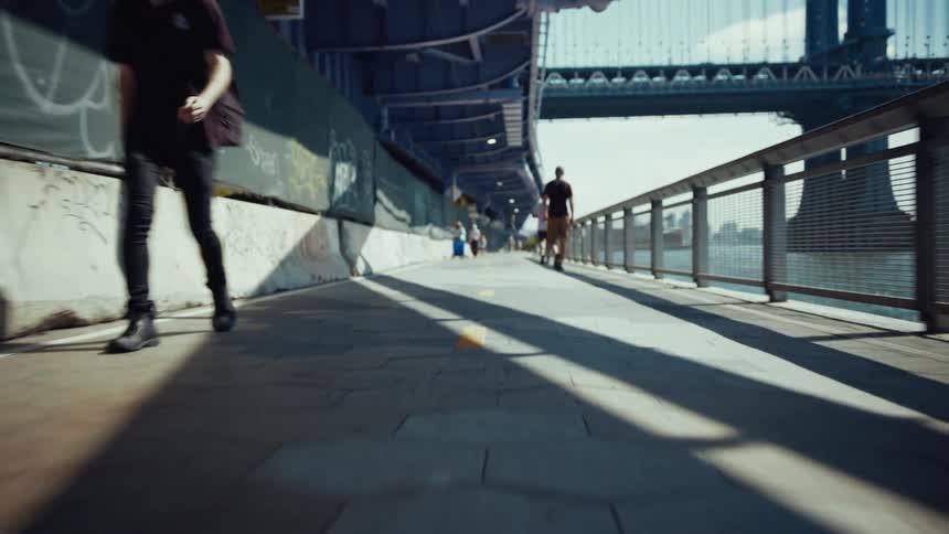 People walk along the water in the city