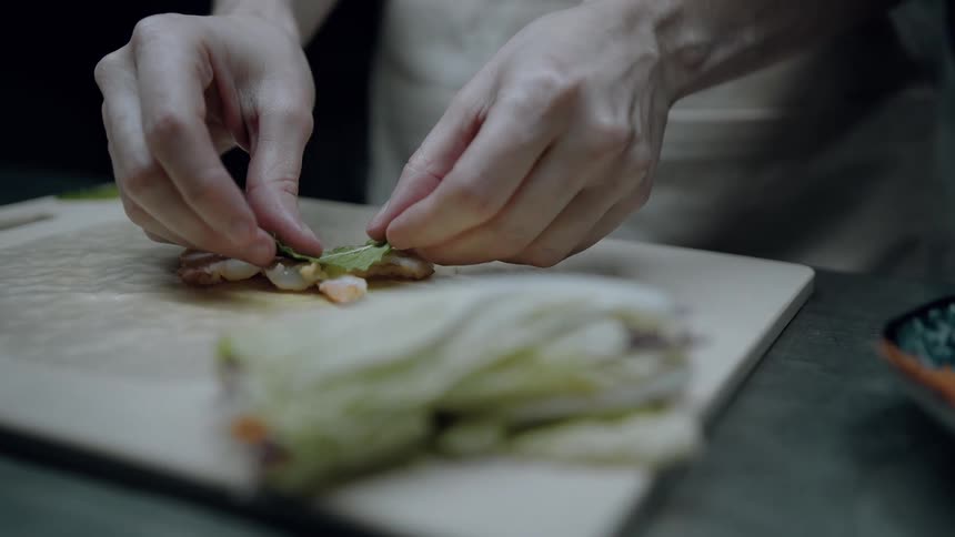 Pair of hands assembling a plate of food