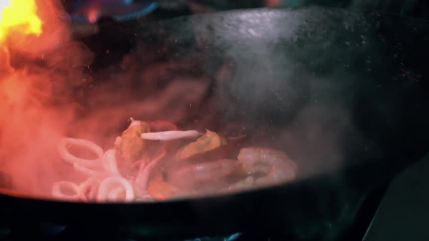 Food is being stirred in the wok