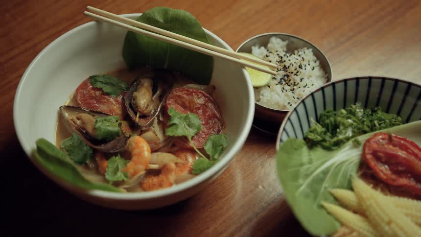 Dishes presented in a bowl including vegetables and mussels