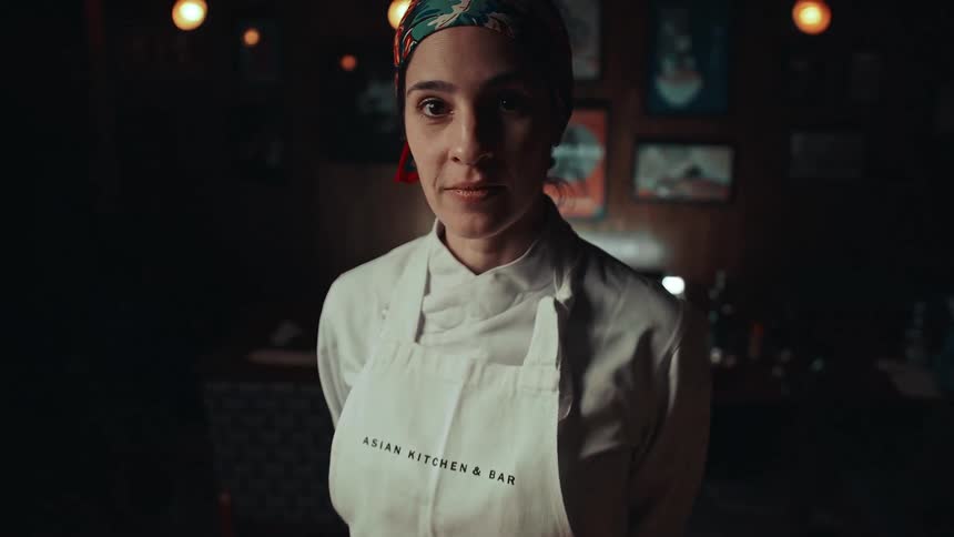 Female chef from asian kitchen bar wearing apron chef coat and head scarf