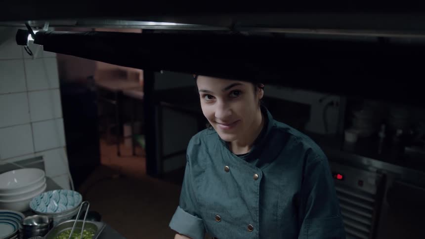 A chef prepares food inside the kitchen