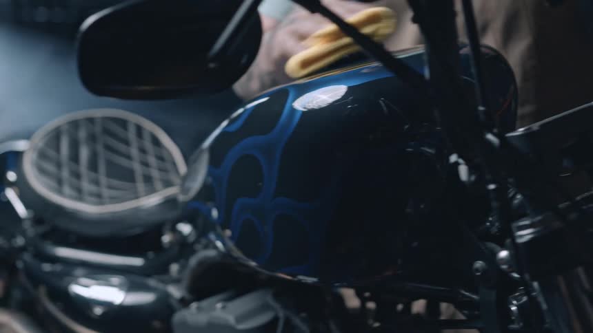 The mechanic polishes the motorcycle