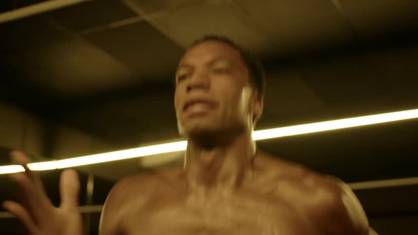 Shirtless man with sweating body warming up