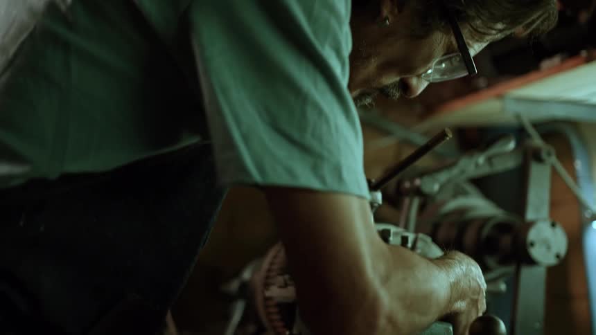 The man is working on repairing the machine