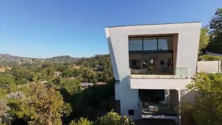 Mansions are in the hills surrounded by trees
